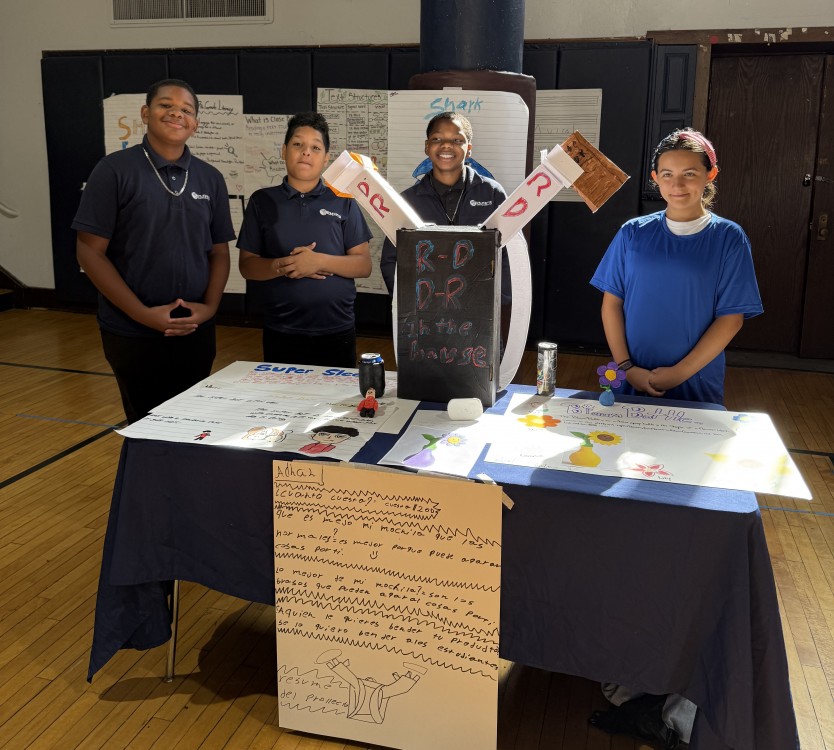 Images of Eugenio Maria de Hostos Charter School students standing with model invention