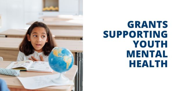 Graphic featuring a student sitting at a desk with a book and a globe. Text says "Grants SUpporting youth mental health"
