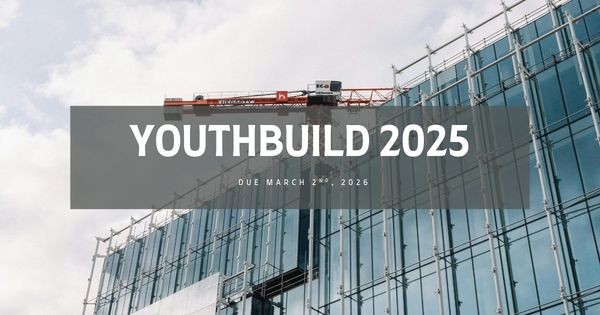 Image of a construction crane by a skyscraper