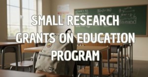 Image of backback on a school desk in a classroom with text that says "Small research grants on education"