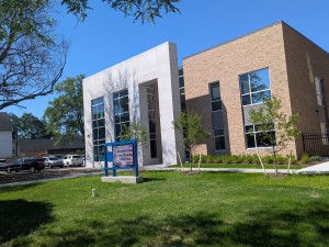 Photograph of a school campus building against a blue sky