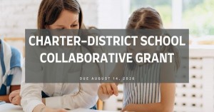 Image of a female teacher and female student talking about a piece of paper on a table.