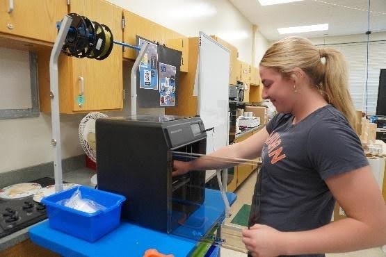 Student using a 3D printer